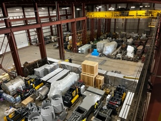 Wide view of Gelock warehouse interior with overhead crane and stored machinery