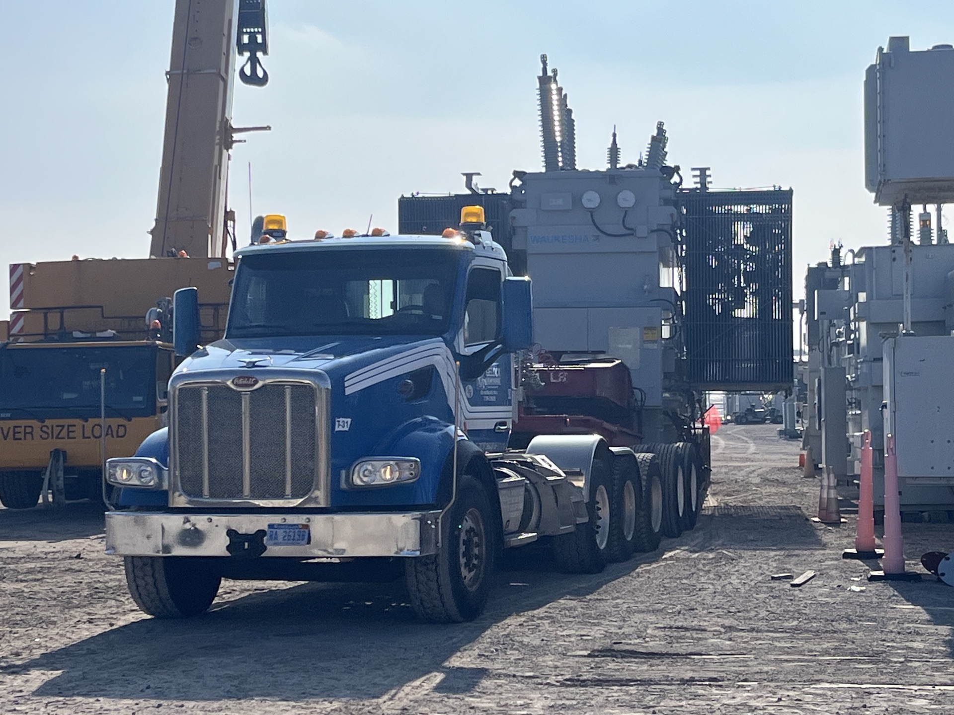 Semi-truck transporting an oversized industrial load on a highway